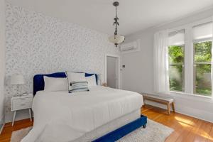 a white bedroom with a bed and a window at Latourette Estate in McMinnville