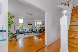 a living room with white walls and wood floors at Latourette Estate in McMinnville