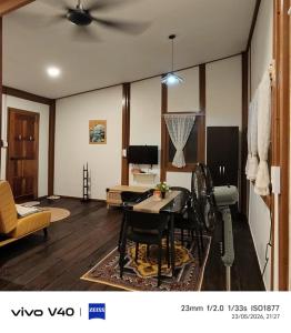 a living room with a ceiling fan and a table at Ciao Bella in Dungun
