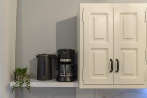 a coffee maker on a shelf in a kitchen at Eudokia's House Platanias in Platanias