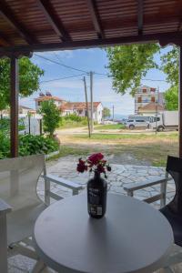 a vase with flowers sitting on a white table at Eudokia's House Platanias in Platanias