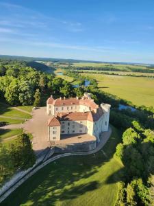 an aerial view of a large house on a green field at Gite L étable du Bien Etre in Ray-sur-Saône