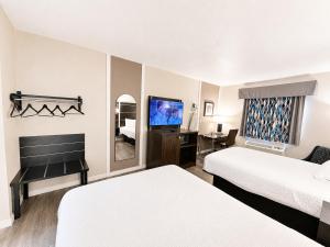 a hotel room with two beds and a flat screen tv at Blaine Town Inn & Suites in Blaine