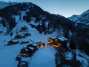 a lodge in the snow at night in the mountains at Chalet Nunavut, Ski in - Ski out with Complimentary Spa Access in Zermatt +6 photos