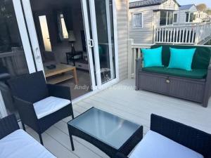 a patio with two chairs and a glass table at 273 Northfield in Skipsea