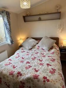 a bedroom with a bed with flowers on it at 273 Northfield in Skipsea