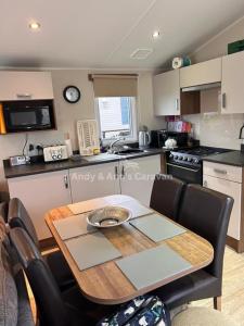 a kitchen with a wooden table and a dining room at 273 Northfield in Skipsea