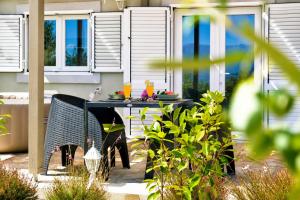 a table with plates of food on it in a garden at Olive Garden Home with Jacuzzi and Privacy in Mirce