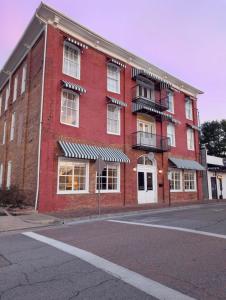 a red brick building on the corner of a street at The Historic Hattie House in Abingdon