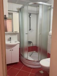 a bathroom with a shower and a sink at Kiraz Otel in Lapseki