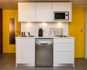 a kitchen with white cabinets and a dishwasher at Les Appartements Carré d'or - Nice Centre in Nice
