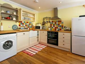 a kitchen with a washer and a dishwasher at The Barn - S4593 in Lochearnhead +8 photos