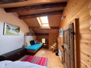 a bedroom with a bed and a couch in a room at Arvenstube - Wergenstein in Wergenstein
