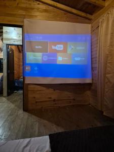 a large screen on a wall in a room at Cabaña del Sol in Medellín