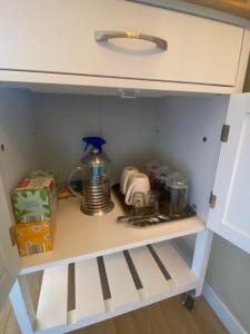 a cupboard in a kitchen with a coffee maker at Chambre & grande Terrasse Privées, Vue Montagne - Chalet Bella Rosa in Argein +30 photos