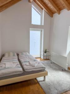 a bedroom with a bed and a large window at Rustico Al Stradon by HolAp SA in Avegno