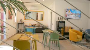 a dining room with tables and yellow chairs at Dimora 5 Sensi in Pozzuolo del Friuli