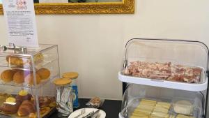 a counter top with a container of ham and other food at Dimora 5 Sensi in Pozzuolo del Friuli +23 photos