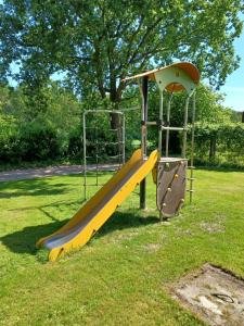 a playground with a slide in the grass at rikobravo in Meppen