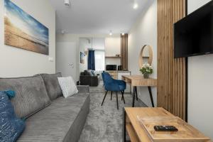 a living room with a couch and a table at A.S.Apartamenty Bożena Bocian in Niechorze