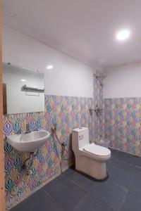 a bathroom with a toilet and a sink at ABI RESIDENCY Hitech City in Hyderabad