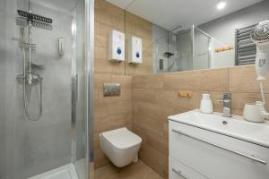 a bathroom with a shower and a toilet and a sink at A.S.Apartamenty Bożena Bocian in Niechorze +92 photos