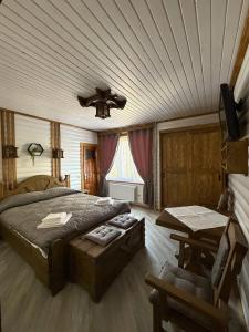 a bedroom with a bed and a ceiling at Ватрич House in Chernivtsi