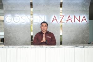 a man is standing in front of a sign at Gosyen Azana Hotel Salatiga in Salatiga +15 photos