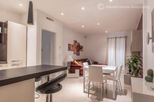 a kitchen and living room with a table and chairs at Dimora San Francesco in Pesaro