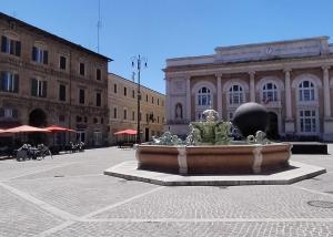 a large fountain in the middle of a city at Dimora San Francesco in Pesaro