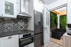a kitchen with a refrigerator and a stove at Apartman Miriam in Opatija