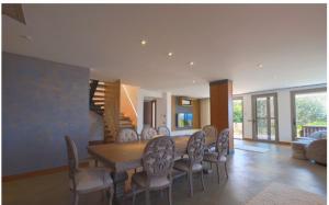 a dining room with a table and chairs at Gümüşlük Infinity Villa Seaview, Pool & Sauna in Bodrum City