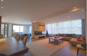a living room with a couch and a table at Gümüşlük Infinity Villa Seaview, Pool & Sauna in Bodrum City