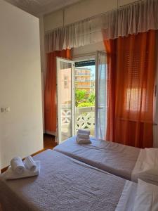 a bedroom with two beds with towels on them at Villa Cristina in Rapallo