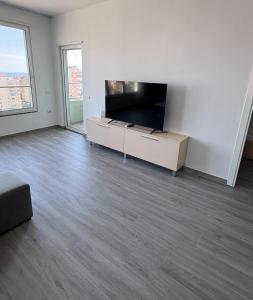 an empty living room with a large flat screen tv at Sea View Apartments in Durrës