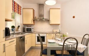 a kitchen with a table with chairs and a counter top at Ferienhaus Alisch Fewo 3 in Warnemünde