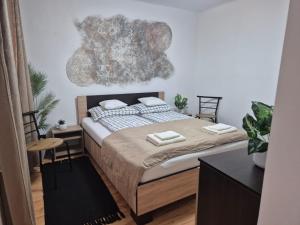 a bedroom with a large bed with two chairs at Kucko Vendeghaz Guesthouse in Sárospatak