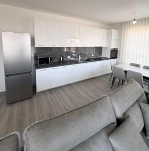 a living room with a couch and a kitchen at Sea View Apartments in Durrës