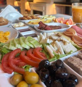 a table with a bunch of different types of food at Nuo Taksim Rooms in Istanbul