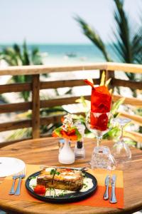 a table with a plate of food on top of it at Blackstone Beach Resort in Uroa