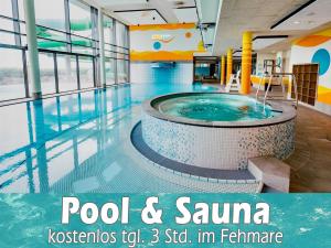 a pool and sauna in a building at Bauernhaus Premium in Fehmarn