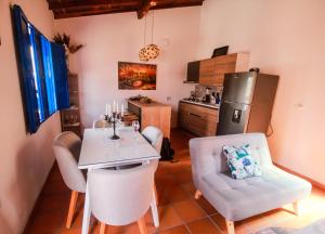 a kitchen with a table and chairs and a refrigerator at Casa Amarilla in San Gil