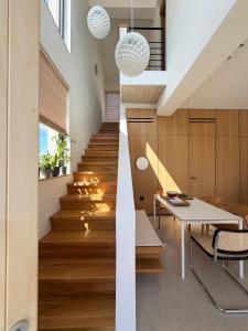 a staircase in a house with wooden floors at The Habitus Residence, a Design house in Corfu