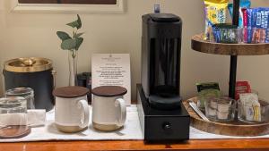 a coffee maker and cups on a counter at Amherst Inn - Virginia in Amherst