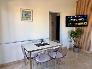a dining room with a white table and chairs at Holiday Home Tanja in Sutivan