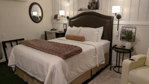 a bedroom with a large bed with a pillow on it at Amherst Inn - Virginia in Amherst