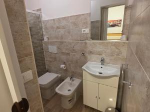 a bathroom with a sink and a toilet and a mirror at Villa Cristina in Rapallo