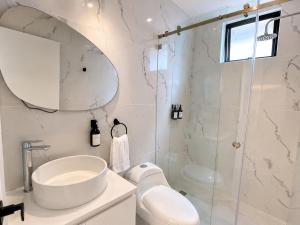 a bathroom with a shower and a sink and a toilet at NIDO Boutique Hotel in Quito +33 photos
