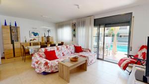 a living room with a couch and a table at Villa Arenal in L'Ampolla