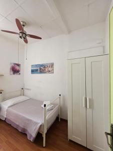 a bedroom with a bed and a ceiling fan at Villa Cristina in Rapallo +12 photos